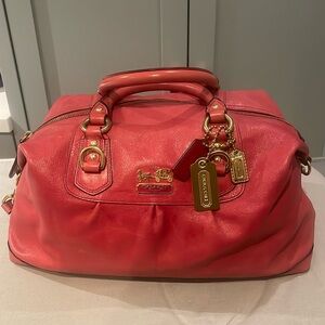 Coach pink leather purse with strap.